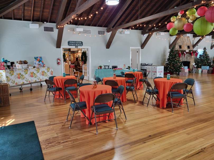 A room decorated with tables, chairs, and balloons