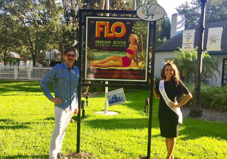 Bob Stanley & Leila, Miss Florida, standing in front of the Flo sign.
